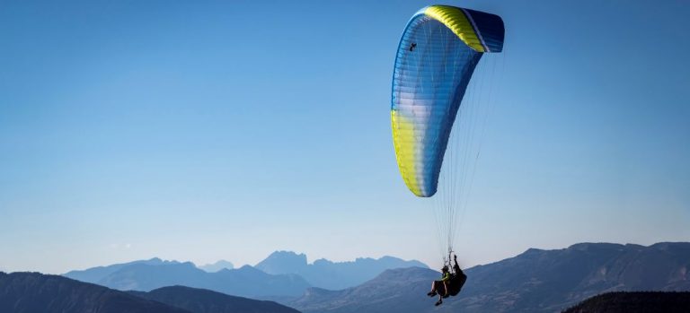 Tandem paraglider soaring above the Southern Alps